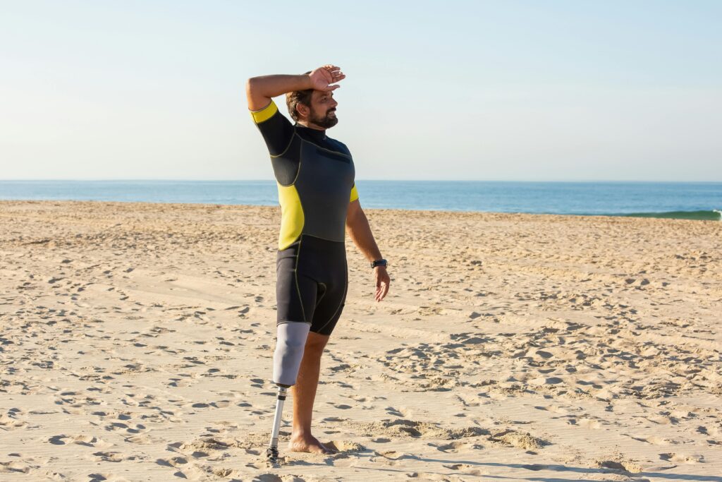 Amputee athlete training on a sunny beach, showing determination and strength.